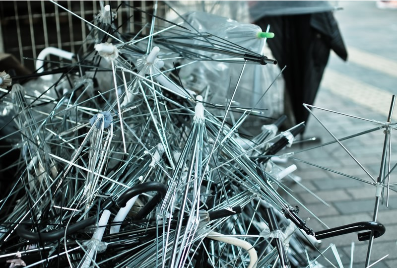 A pile of broken umbrellas